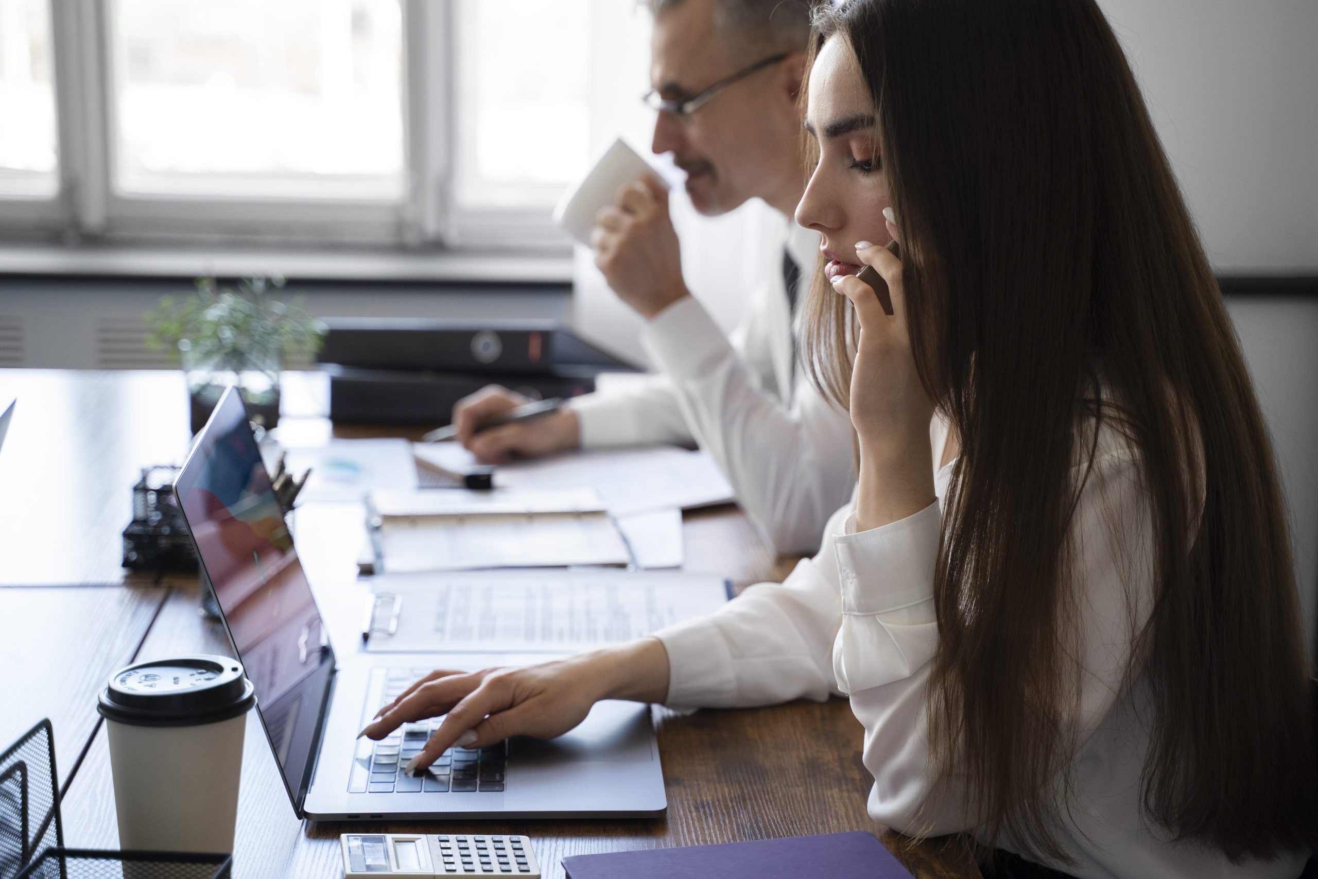 Insurance agents processing a roof insurance claim in a modern office.